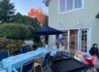 Backyard hibachi party setup with grill, table seating, and birthday decorations before guests arrive