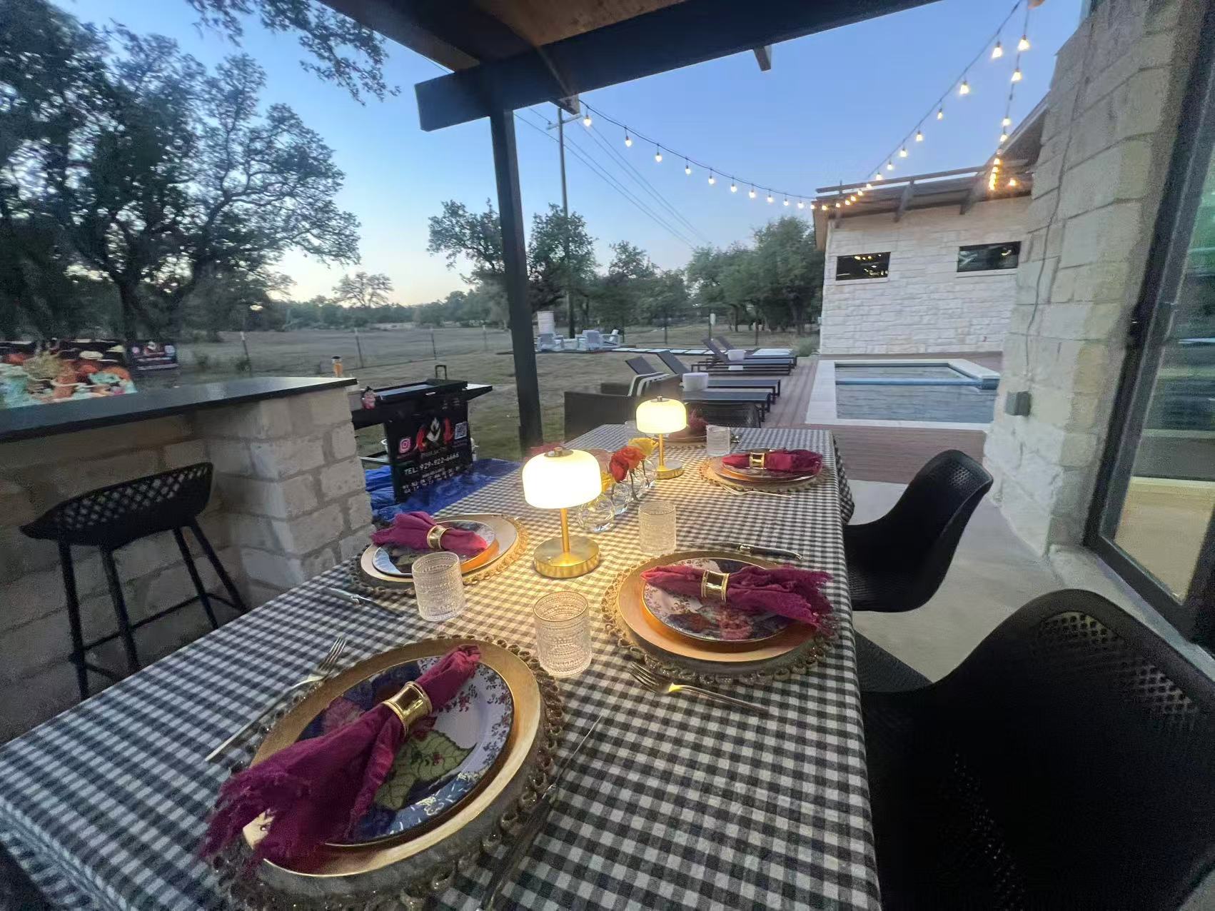 Covered patio dining setup prepared for an at-home hibachi party with table settings and outdoor seating