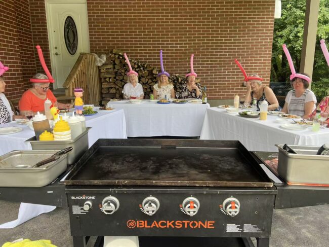 U-shaped table seating arranged around a private hibachi grill for an at-home dinner party