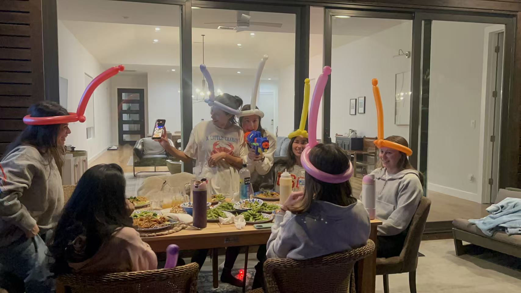 Kids and adults seated around an at-home hibachi grill during a family dinner party