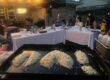 Private hibachi chef serving a signature hibachi party menu with steak, shrimp, and fried rice at an at-home dinner