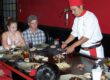 Hibachi dinner table at a teppanyaki restaurant with chef-grilled dishes served in front of guests