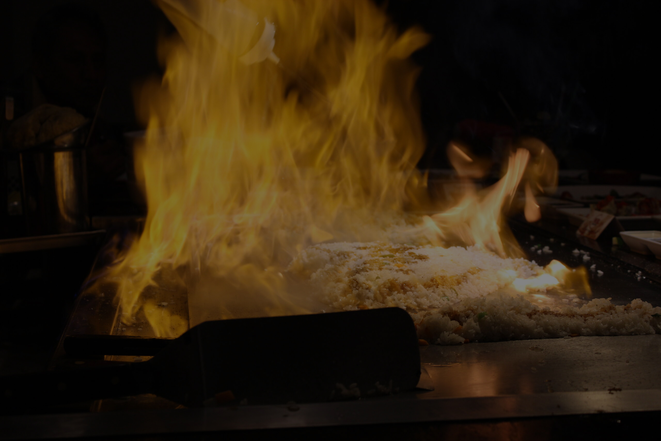 Hibachi Royal chef tableside teppanyaki service building a signature dining course